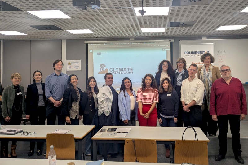 A group image of 10 women and three men in front of a presentation screen showing "ClimateAmbassadors".