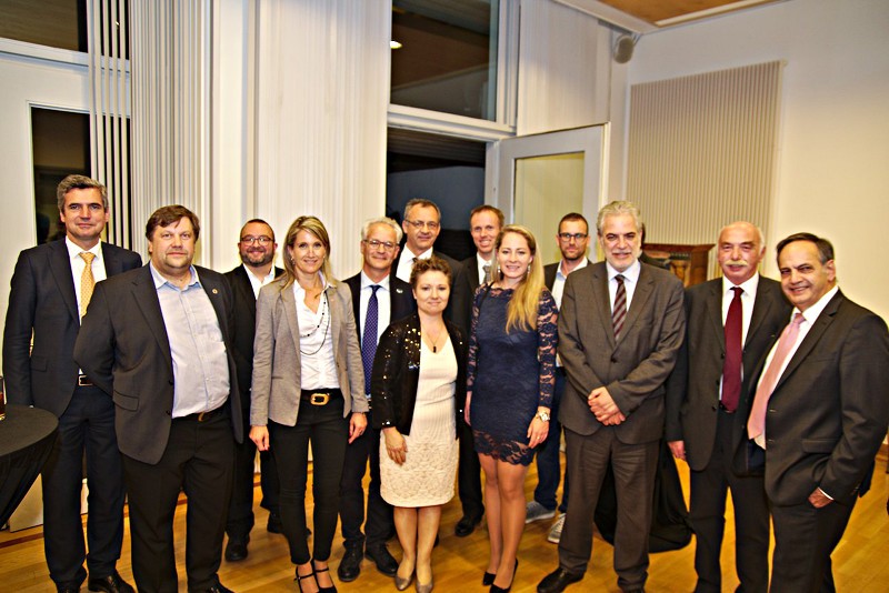 A group of representatives of the Samaritan organisations and other participants in the parliamentary evening poses for a photo with Commissioner Stylianides